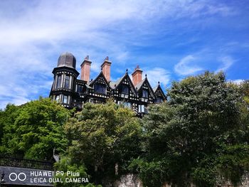 Low angle view of traditional building against blue sky