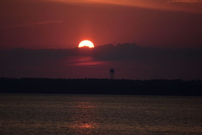 Scenic view of sea against romantic sky at sunset