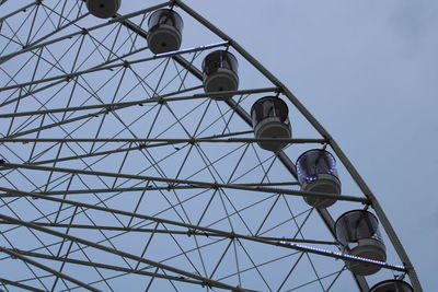 Low angle view of ferris wheel against sky