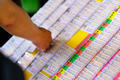 High angle view of man holding lottery paper