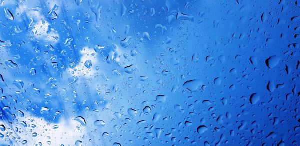 Full frame shot of wet glass window during rainy season