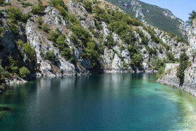 Scenic view of waterfall in mountains