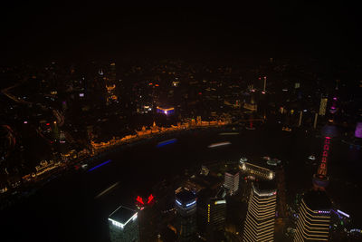 High angle view of illuminated buildings in city at night