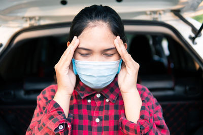 Portrait of young woman in car