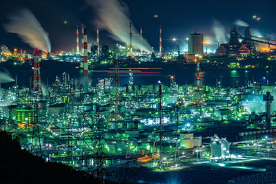 Illuminated cityscape against sky at night