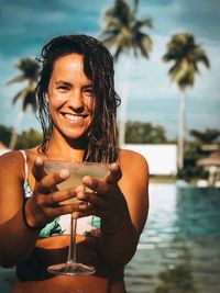 Portrait of smiling young woman in swimming pool