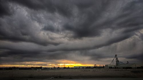 Storm clouds over city during sunset