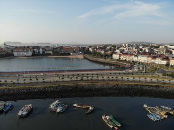 High angle view of river and buildings against sky