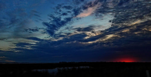 Scenic view of landscape against cloudy sky