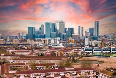 High angle view of buildings in canary wharf against sky during sunset