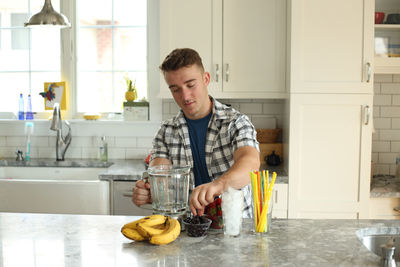 Young woman eating food at home