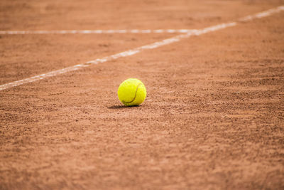 Close-up of tennis yellow ball on field