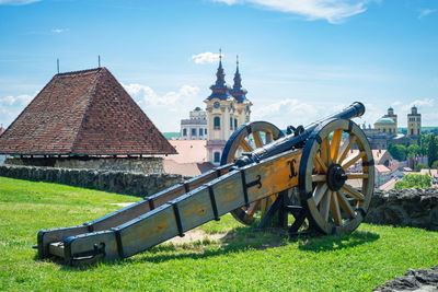 Traditional windmill on field against sky