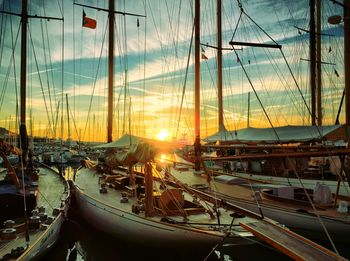 Boats at harbor during sunset