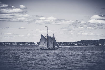 Sailboat sailing on sea against sky