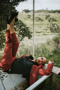 Portrait of young man lying down on land