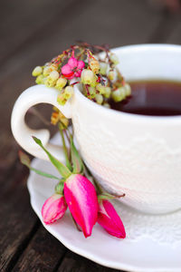 Close-up of tea cup and flowers