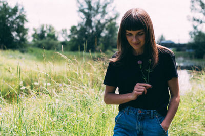 Young woman standing on field