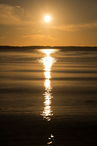 Scenic view of sea against romantic sky at sunset