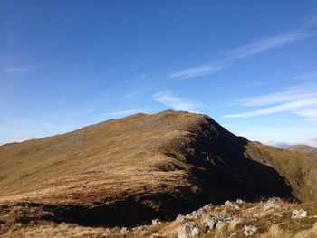 Scenic view of mountains against blue sky