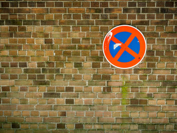 Road sign on brick wall