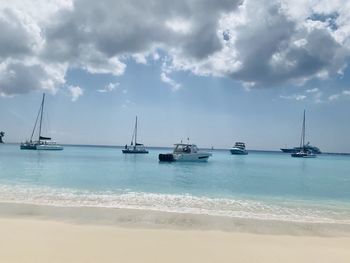 Sailboats on sea against sky