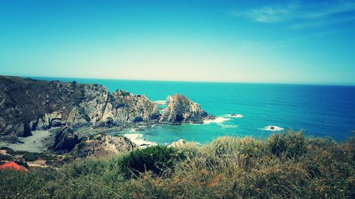 Scenic view of sea against clear blue sky