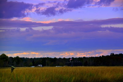 Scenic view of field against cloudy sky