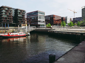 Bridge over river against buildings in city