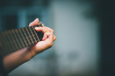 Close-up of hand playing guitar