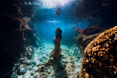 Rear view of woman swimming in sea