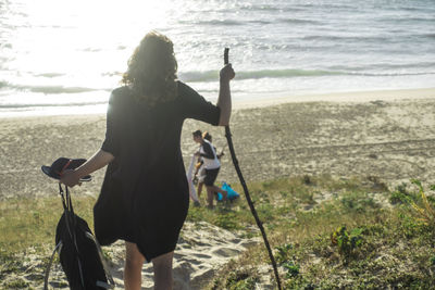 Silhouette of woman walking on beach