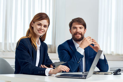 Young couple sitting on table