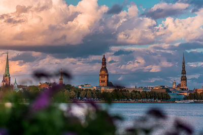 Buildings against cloudy sky