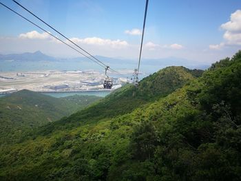 Scenic view of overhead cable car against sky