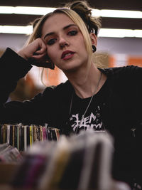 Portrait of young woman sitting at restaurant