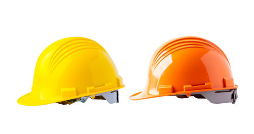 Close-up of yellow hardhat against white background