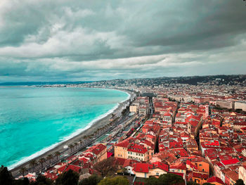 High angle view of buildings and sea against sky