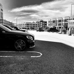 Cars parked on road against buildings in city