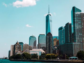 Skyscrapers in city against blue sky