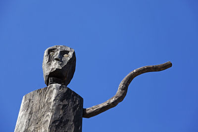 Low angle view of statue against clear blue sky