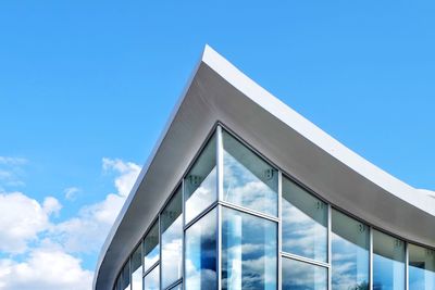 Low angle view of modern building against blue sky