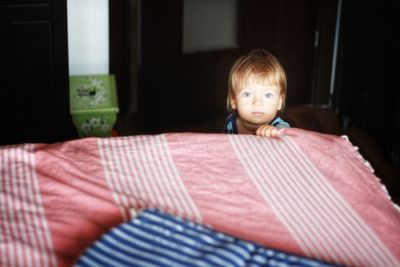 Portrait of boy sitting at home