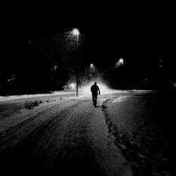 Rear view of people walking on road