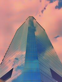 Low angle view of modern building against sky during sunset