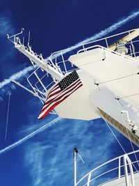 Low angle view of sailboat against blue sky