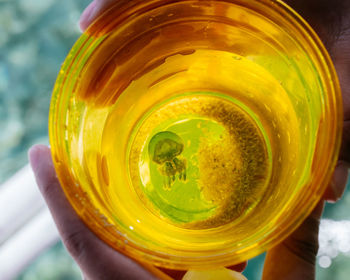 Close-up of hand holding drink in jar