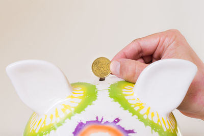 Close-up of hand on table against white background