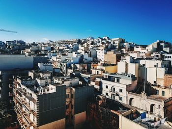 High angle view of cityscape against clear blue sky