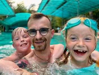 Portrait of happy girl with swimming pool